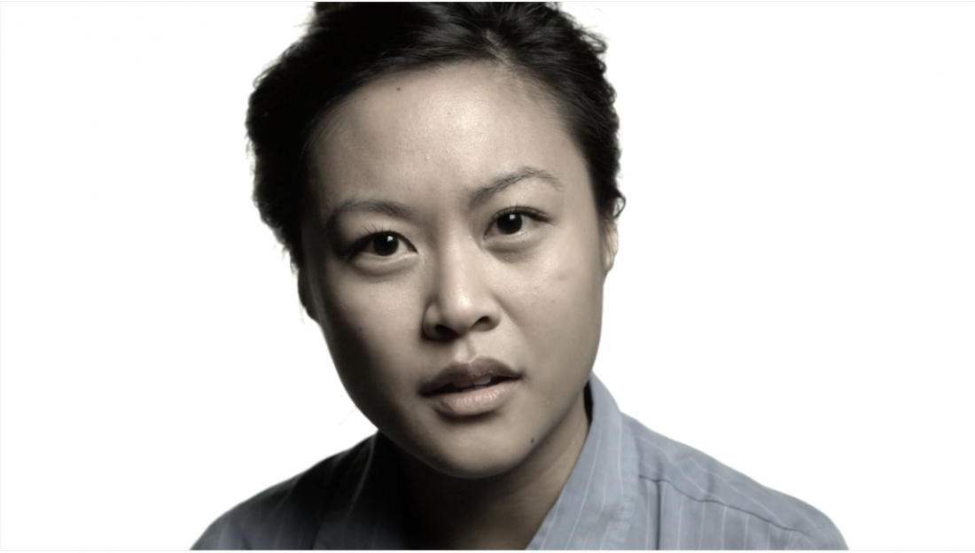 Image of a young woman in a blue-collar shirt, looking forwards.